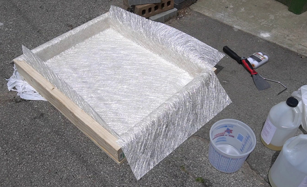 Layed out the fibreglass mats for the first coat.