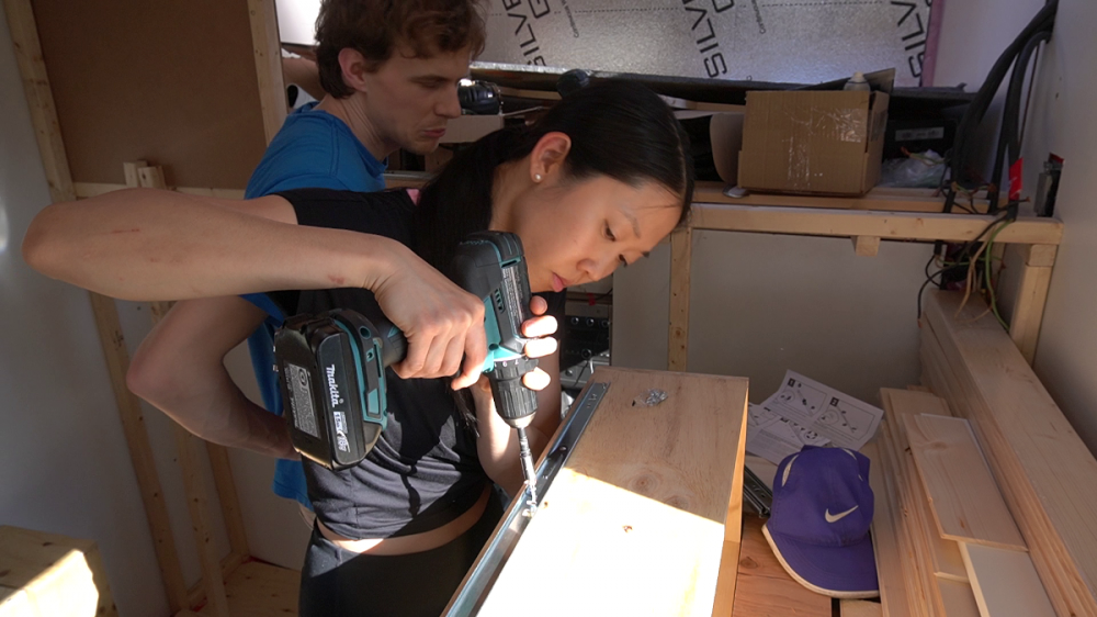 Sachiko installing the drawer slides. Hah, Moritz's expression in the back.